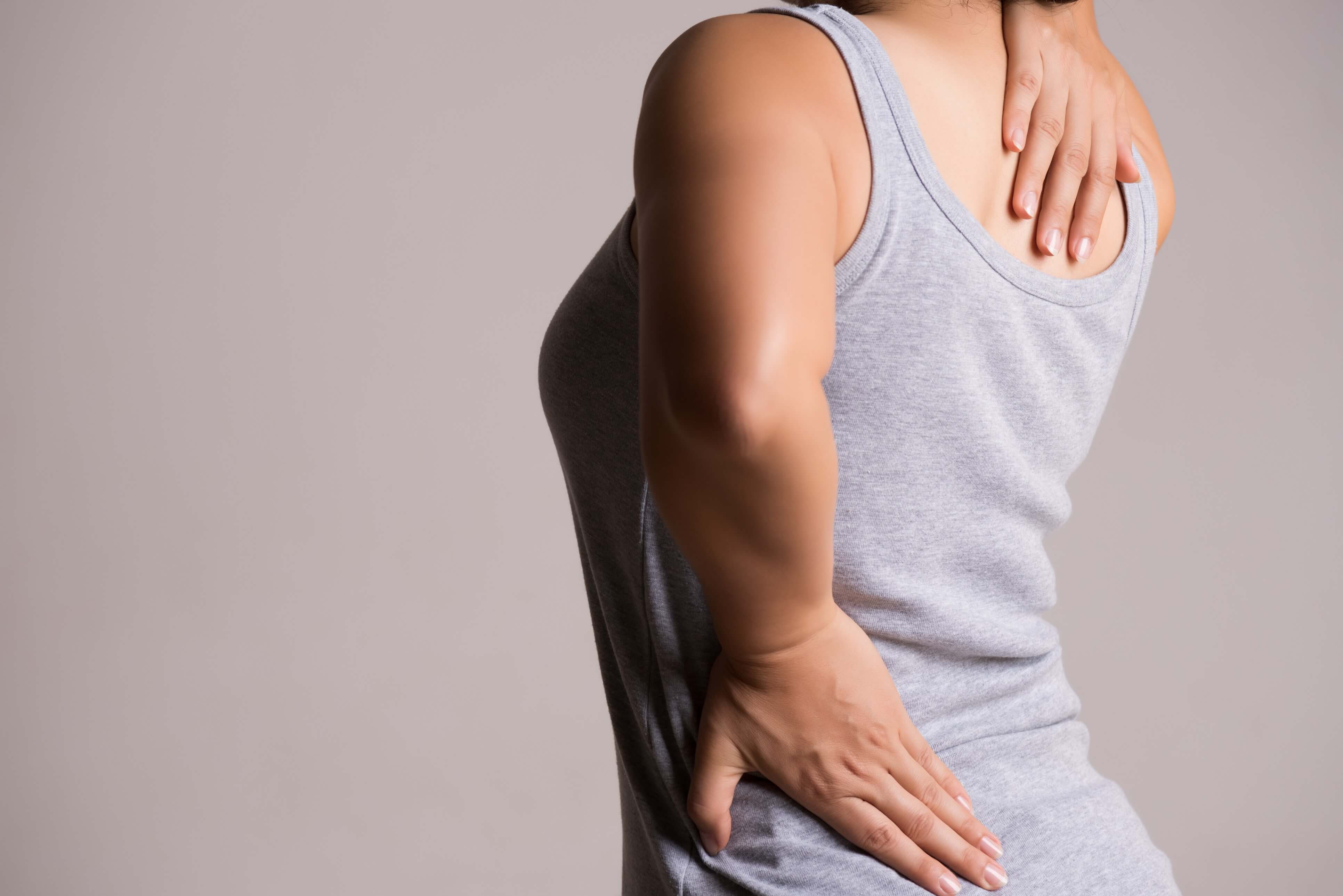 Page Banner: Woman gripping her lower and upper back in pain